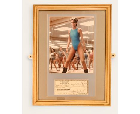 Jamie Lee Curtis signed cheque 08/09/1980 with colour photo from the movie Perfect. Framed. Measures 14 inch by 17-inch appx.