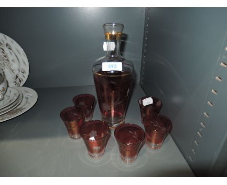 A cranberry decanter and glasses