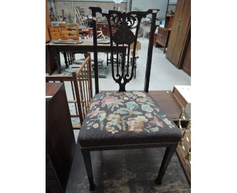 A late Victorian mahogany salon chair in the Art Nouveau style having inlay decoration and tapestry seat