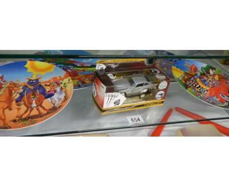 A boxed Corgi Casino Royale Aston Martin DB5 and four McDonalds 1998 melamine plates.