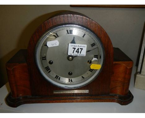 A 1938 oak mantel clock (for 51 years service), with key and in working order.