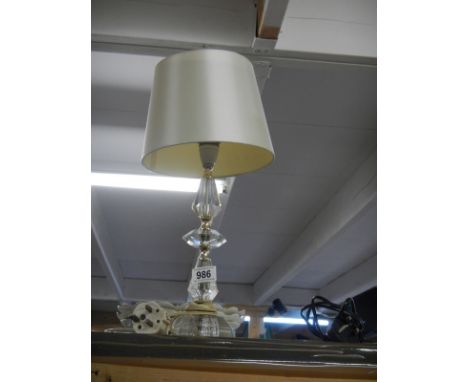 A heavy glass table lamp with shade.