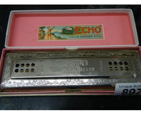 A boxed vintage Hohner Echo harmonica.