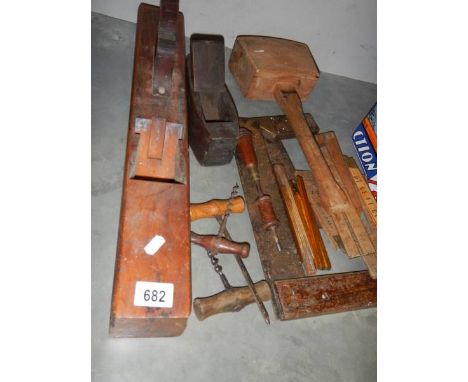 A quantity of vintage carpenter's tools including planes, measures, cork screws etc.,