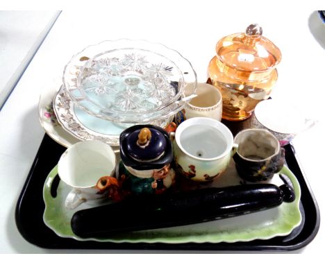 A tray containing miscellaneous to include an antique glass rolling pin, commemorative mugs, plates, glass comport etc