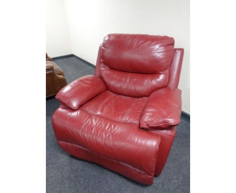 A red leather manual reclining armchair 