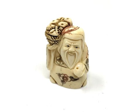 A carved hardwood Chinese netsuke - Village elder with bread basket
