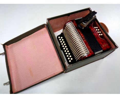 A case containing Hohner Erica accordion together with a further Hohner mouth organ  