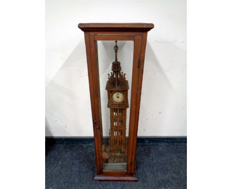 A fretwork wooden model of Big Ben with clock movement in a pitch pine and glass display case, height 105 cm 