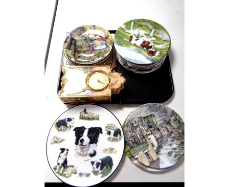 A tray containing a Bradford Exchange Lamp Light Lane heirloom porcelain clock by Thomas Kinkade, together with a quantity of