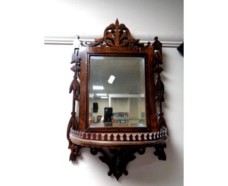 A Victorian fretwork framed mirror with demi lune shelf 