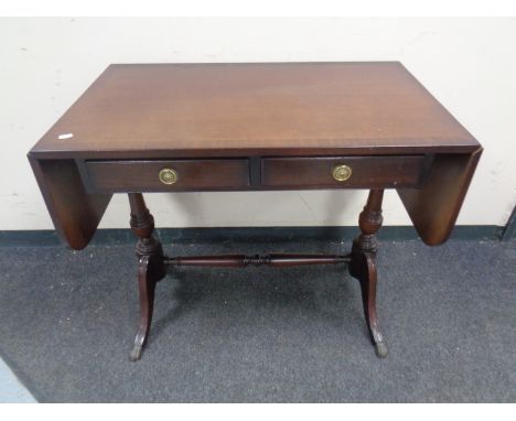 A regency style inlaid mahogany flap sided sofa table fitted two drawers  