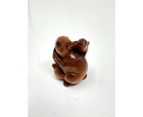 A carved hardwood Chinese netsuke - Two rabbits 