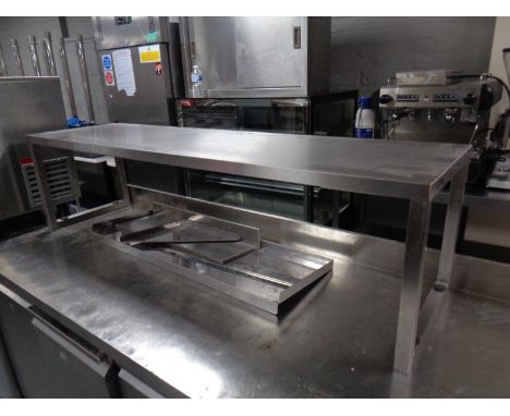 A stainless steel counter top shelf, width 156 cm and two further stainless steel shelves one with wall brackets 