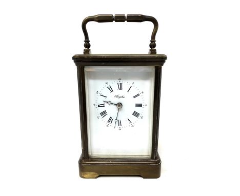 A brass cased eight-day carriage clock by Angelus, height 17 cm, complete with brass winding key. 