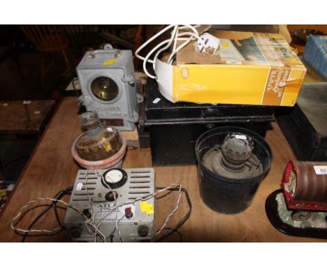A vintage combined ultra violet and infrared sun lamp (boxed) a tin safety box, an atlas type A3 battery charger, oil lamps, 