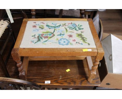 An oak string seated stool together with a light oak tapestry seated and barley twist stool 