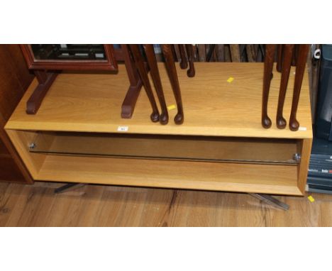 A modern light oak and chrome tv stand, with toughened glass shelf and chrome effect feet 