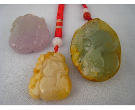 A mixed lot comprising three various Chinese jade pendants, largest approx 8cm.