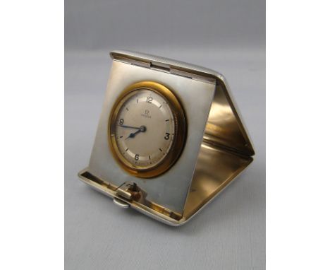 A silver cased Omega travelling clock with engine turned cover, the case by Carrington &amp; Co, London, 1915, approx. 8 cm x