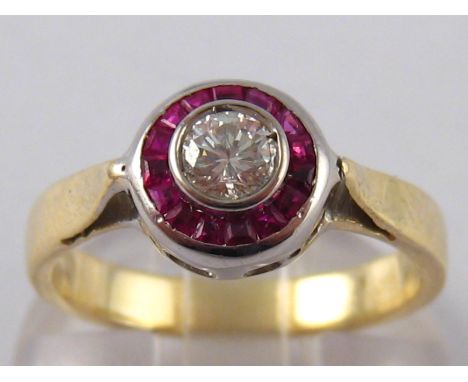 A yellow metal (tests 14 carat gold) ruby and diamond ring, the round brilliant cut diamond measuring approx 4.8 x 2.8mm deep