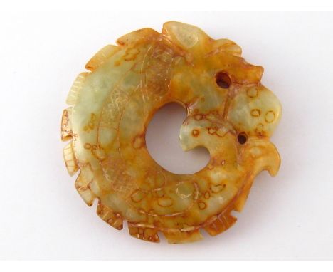 A carved and engraved Chinese jade pendant, approx 5.5cm wide.
