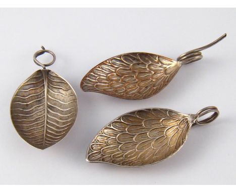 Three Georgian leaf shaped caddy spoons with tendril handles, one with veins, unmarked, and two with feathers , one maker's m