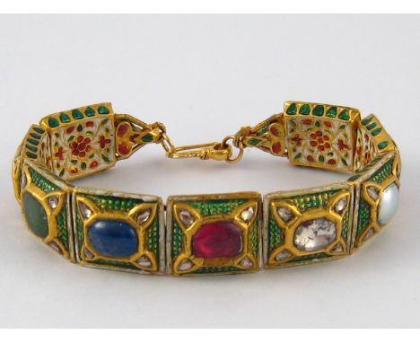 An Indian yellow metal (tests high carat gold) cased, enamelled and multi gem set bracelet; the stones including ruby, diamon