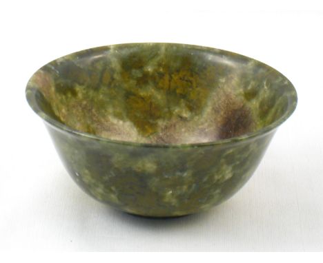 A Chinese turned dark green jade bowl, 10cm dia. 