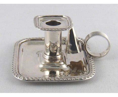 A small silver rectangular chamber candlestick with gadrooned rim and reeded loop handle by Nathan and Hayes, Chester, 1904, 