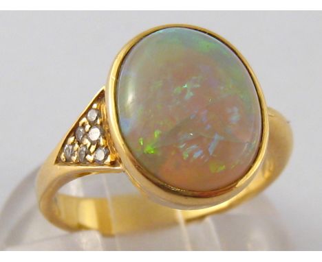 A yellow metal (tests 18 carat gold) opal and diamond ring, opal approx 12 x 9mm, ring size J, 3.9 gms.
