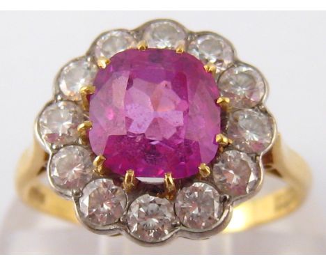 An 18 carat gold ruby and diamond ring, the cushion shape ruby measuring approx 7 x 6.5mm, estimated total diamond content ap