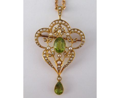An antique 15 carat gold Art Nouveau seed pearl and peridot pendant with brooch fitting, 5 x 3 cm, 5.2 gms, on a 9 carat gold