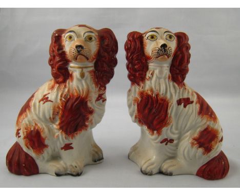 A pair of 19th century, well modelled and painted Staffordshire ceramic flatback King Charles spaniels, approx. 18 cm high. 