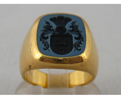 A yellow metal (tests 18 carat gold) signet ring with intaglio engraved agate seal, agate approx 13 x 11mm, ring size K, 13.8