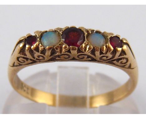 A 9 carat gold garnet and opal ring, circa 1900, ring size P, 2.6 gms.
