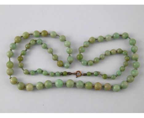 A graduated jade bead necklace, beads approx 7.7 -4.6mm, necklace approx 60cm long.