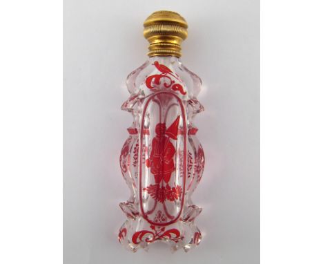 A gold mounted carved glass scent bottle with flashed ruby decoration. Length 11.5cm. 