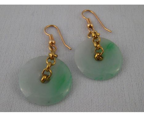 A pair of jade disc earrings with yellow metal (tests gold) fittings, jade approx 2cm diameter, drop approx 4.5cm.