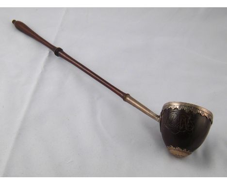 A late 17th century silver mounted coquilla nut punch ladle with vandyke rim and turned hardwood handle. c. 1690.