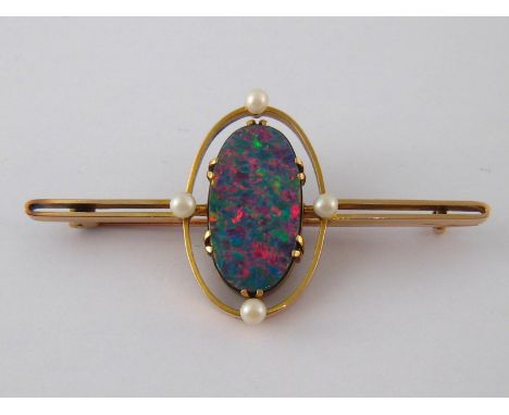  A yellow metal (tests 9 carat gold) opal doublet brooch, opal approx 23 x 12mm, brooch approx 6cm long, 10 gms.