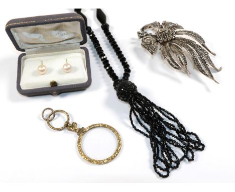 A silver marcasite set brooch in the form of a floral spray; a gilt metal magnifying glass; a black jet necklace; and a pair 