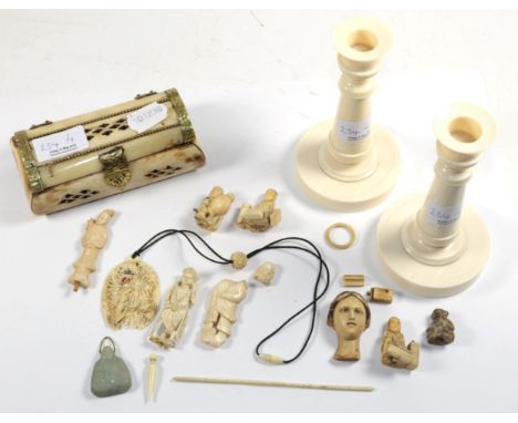 A pair of ivory candlesticks, first quarter 20th century; a bone casket; and a box of small ivory 