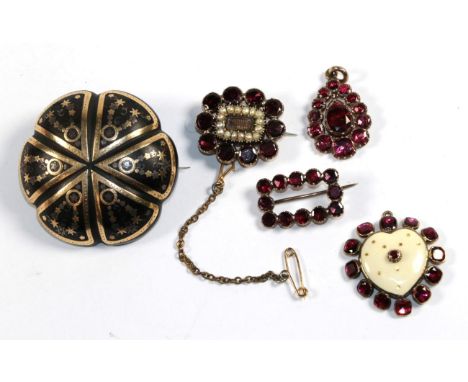 A 9 carat gold enamel garnet set heart shaped pendant, length 2.7cm; two Victorian garnet set brooches; a further Victorian g