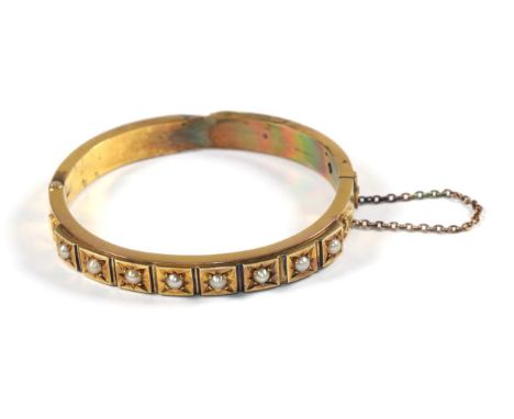 A 15 carat gold pearl and blue enamel bangle, inner diameter 5.5cm by 5cm (a.f.).  Gross weight - 19.88 grams. 