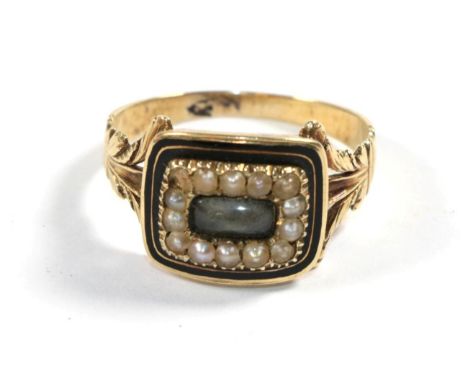 A George III enamel and seed pearl mourning ring, with inscription and dated 1828, finger size O1/2.  Gross weigth - 3.43 gra