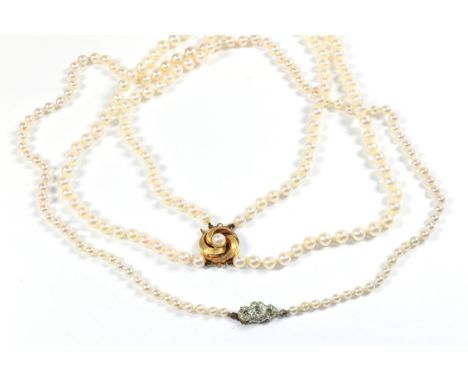 Two cultured pearl necklaces, one with clasp stamped '750', lengths 43cm and 54cm (2)