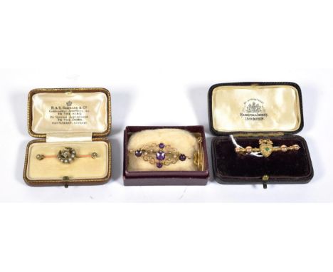 An amethyst and seed pearl bar brooch, stamped '15CT', length 4.1cm; together with three other bar brooches (a.f.) (4).  Amet