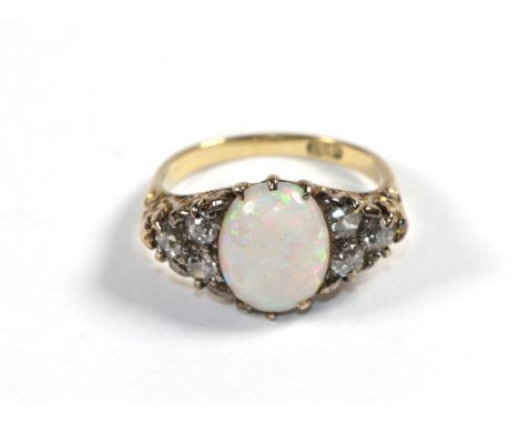 An opal and diamond dress ring, stamped '18CT', finger size O1/2.  Gross weight - 5.1 grams. 