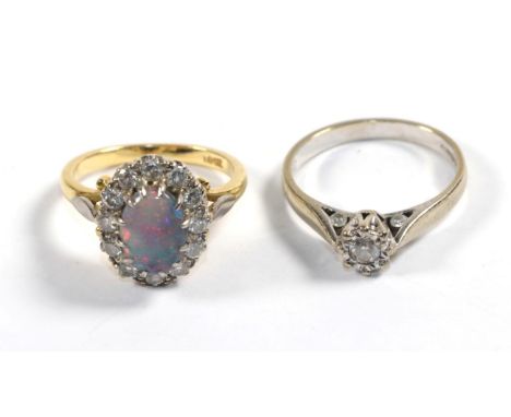 An 18 carat white gold solitaire diamond ring, finger size M1/2; and an opal and diamond cluster ring, stamped '18CT', finger